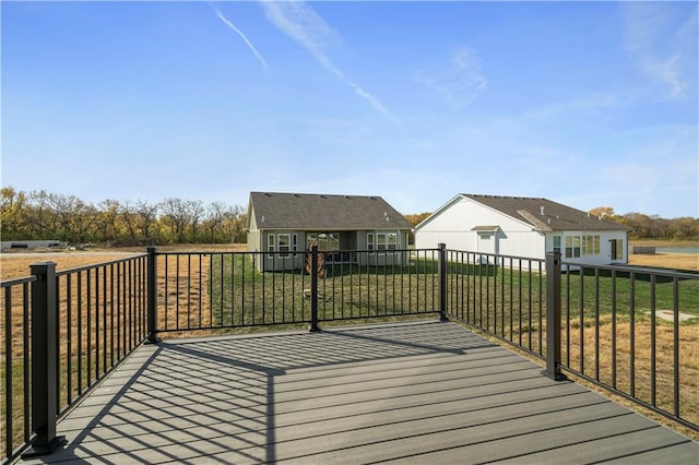 wooden terrace featuring a lawn