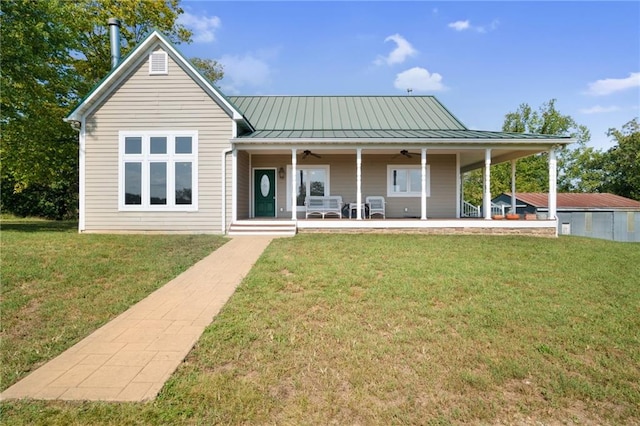 rear view of property with a lawn and ceiling fan