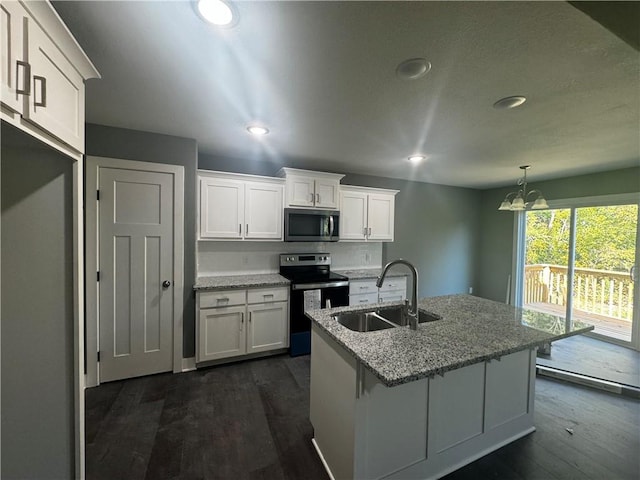 kitchen featuring appliances with stainless steel finishes, dark wood-type flooring, sink, a notable chandelier, and white cabinets