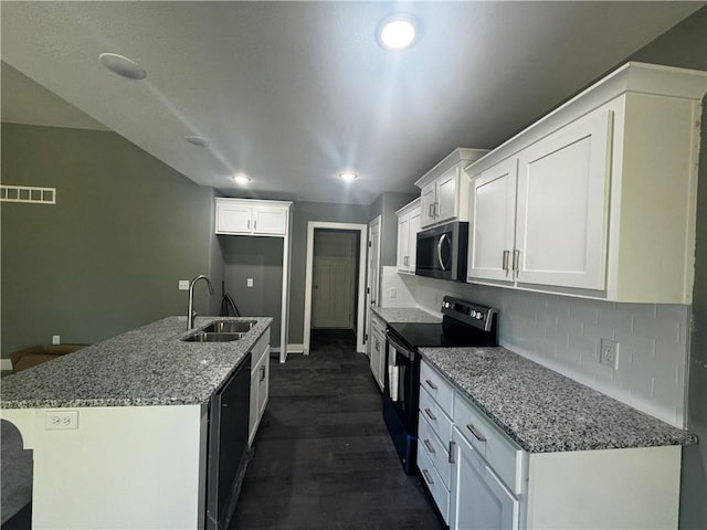 kitchen with light stone countertops, white cabinetry, sink, dark hardwood / wood-style floors, and black appliances