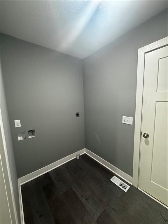 clothes washing area with electric dryer hookup and dark hardwood / wood-style floors