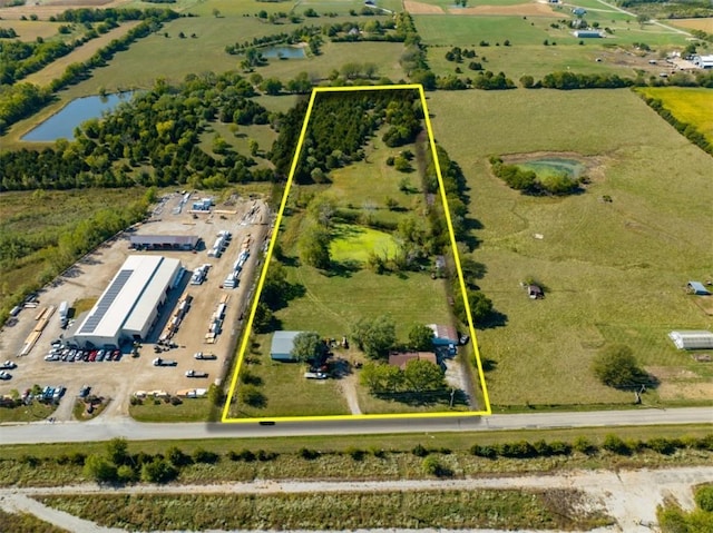 birds eye view of property with a rural view and a water view