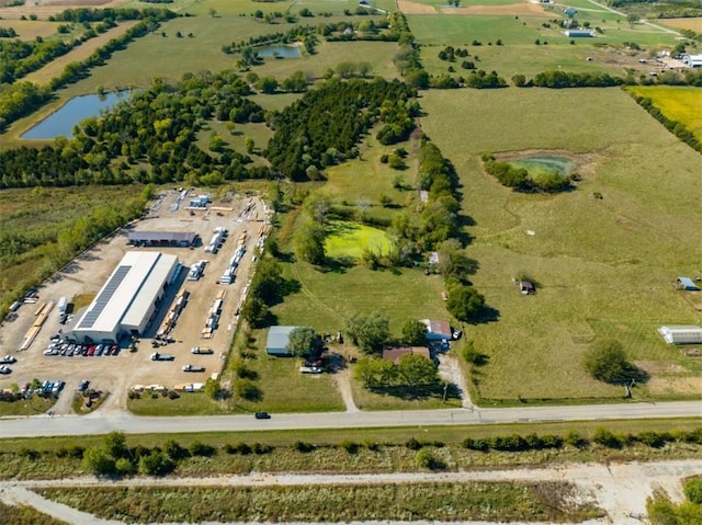 birds eye view of property featuring a rural view and a water view