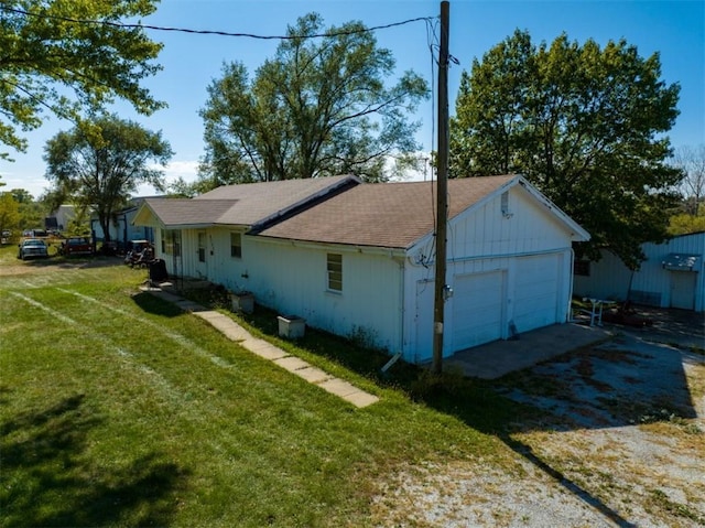 view of property exterior with a yard and a garage