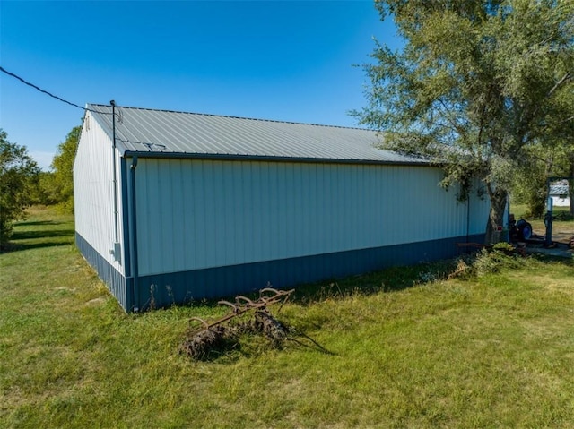 view of side of home with a yard