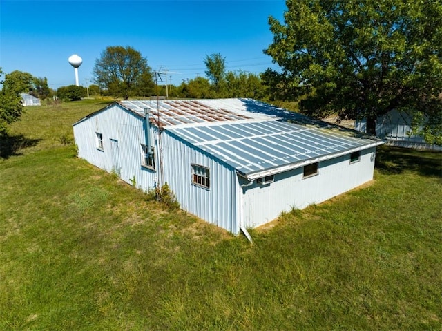 view of side of home featuring solar panels and a lawn