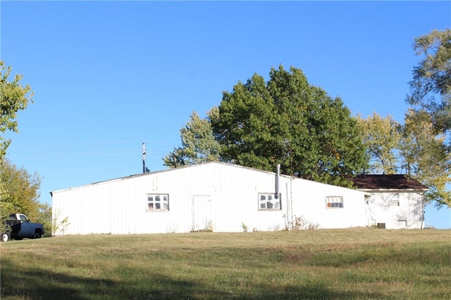 view of property exterior with a lawn