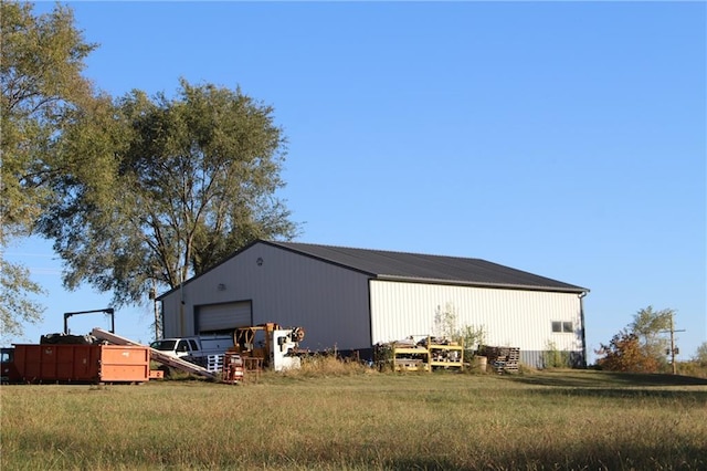 exterior space with a yard and a garage