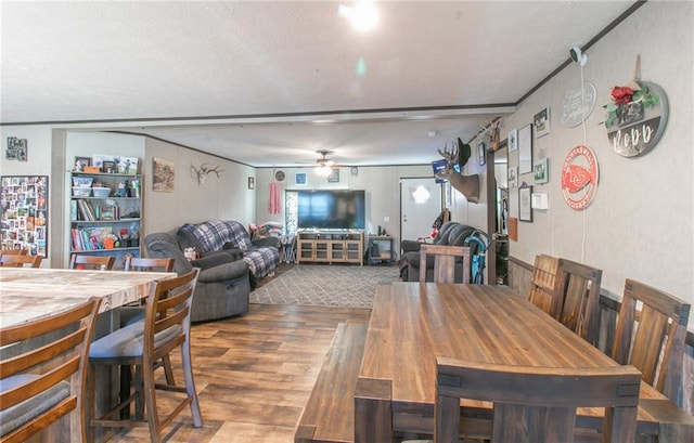 dining area featuring ceiling fan, a textured ceiling, and dark hardwood / wood-style flooring