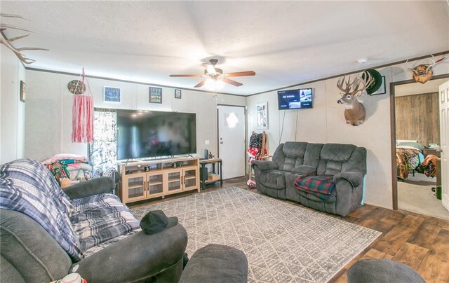 living room with wood-type flooring and ceiling fan