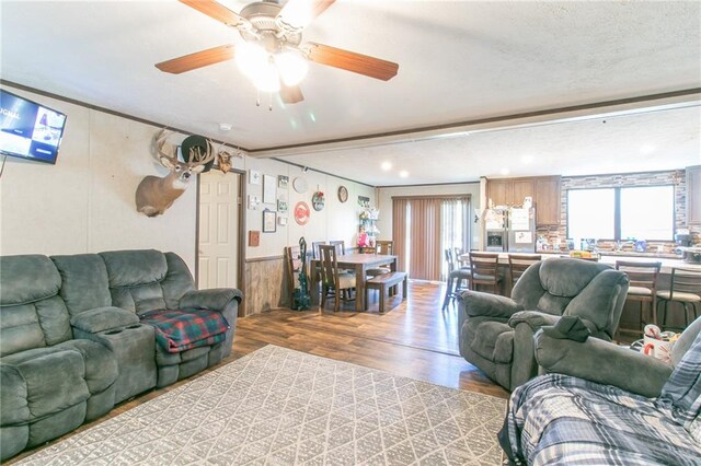 living room with light hardwood / wood-style floors and ceiling fan