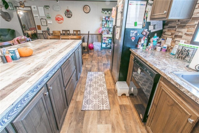 kitchen featuring dishwasher, wood counters, ceiling fan, and light wood-type flooring