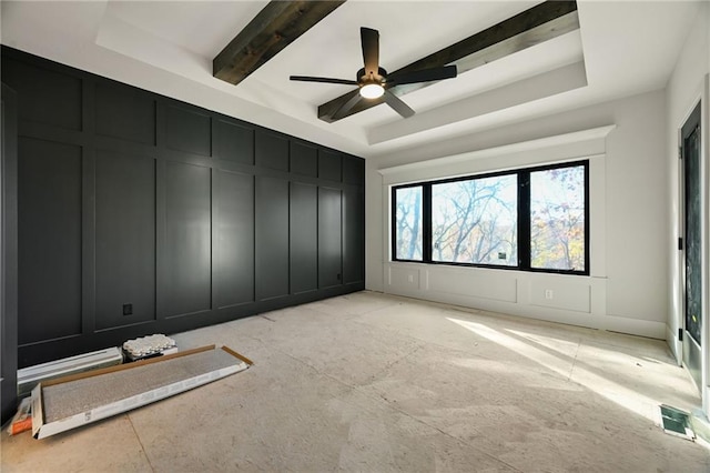 spare room with ceiling fan, beamed ceiling, and a tray ceiling