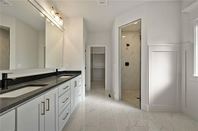 bathroom with walk in shower and vanity