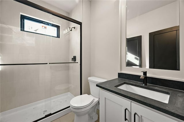 bathroom featuring toilet, an enclosed shower, vanity, and tile patterned floors