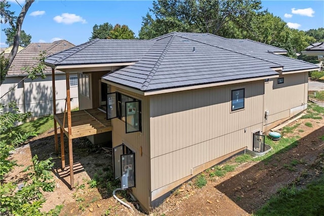 111 Teton Rdg, Lake Winnebago, MO 64034 - view of side of home with a deck and a tile roof