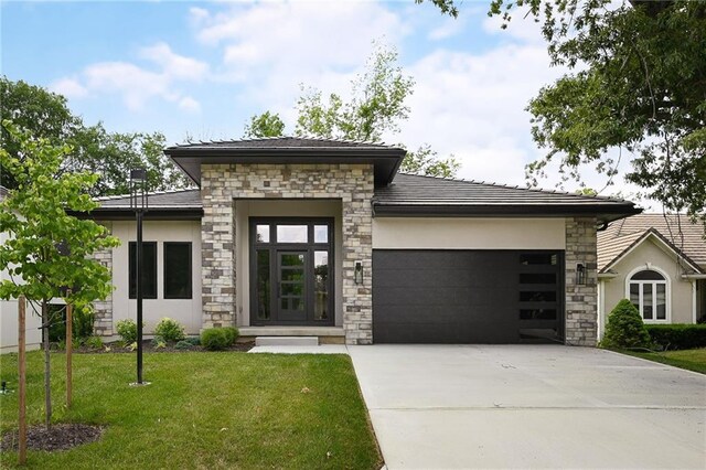 111 Teton Rdg, Lake Winnebago, MO 64034 - view of front of house featuring stone siding, an attached garage, concrete driveway, a front yard, and stucco siding