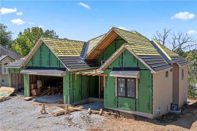 rear view of house with a garage