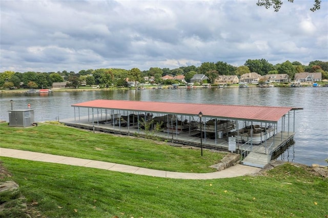 view of dock featuring a lawn and a water view