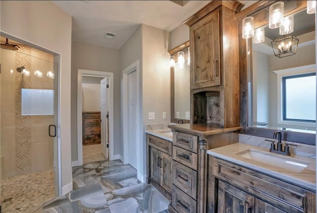 bathroom with vanity, an enclosed shower, and a notable chandelier