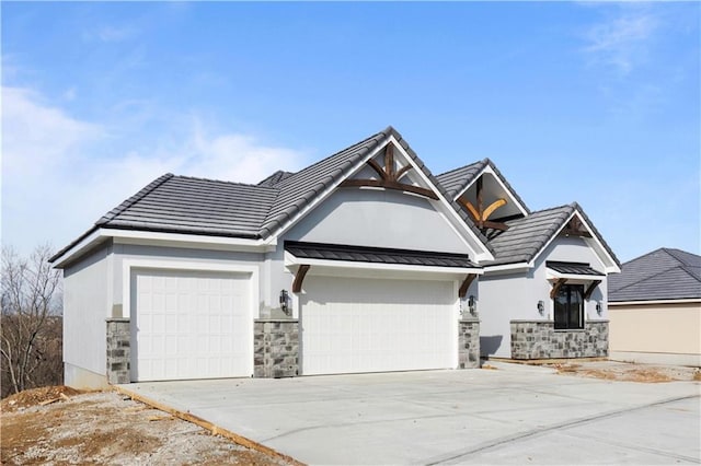 view of front facade featuring concrete driveway, a standing seam roof, metal roof, a garage, and stone siding