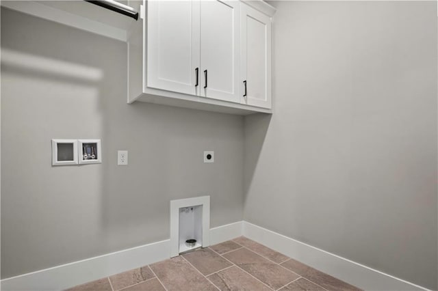 laundry area with washer hookup, cabinet space, stone finish floor, hookup for an electric dryer, and baseboards