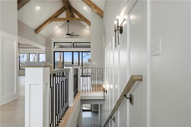 stairs featuring high vaulted ceiling, recessed lighting, beamed ceiling, and wood finished floors