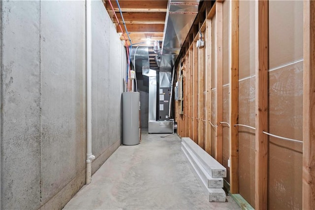 unfinished basement featuring heating unit and water heater