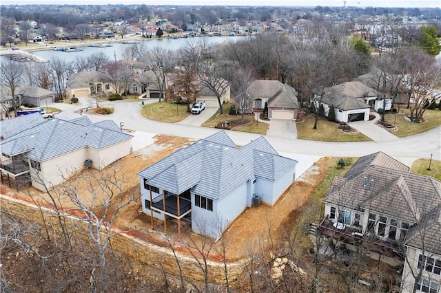 bird's eye view featuring a water view and a residential view