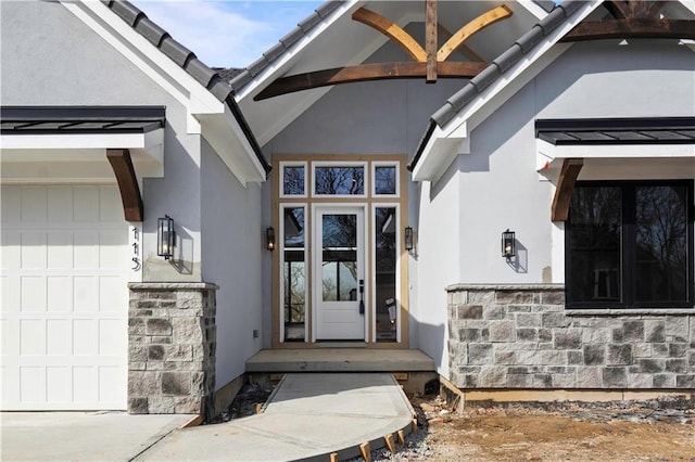 115 Teton Rdg, Lake Winnebago, MO 64034 - property entrance with stucco siding, an attached garage, and stone siding