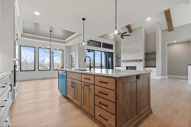 115 Teton Rdg, Lake Winnebago, MO 64034 - kitchen featuring dishwashing machine, a ceiling fan, light wood finished floors, a kitchen island with sink, and beam ceiling