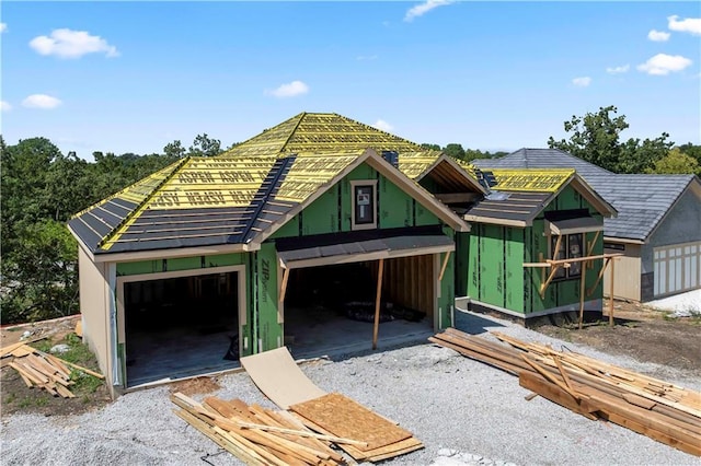 property in mid-construction featuring a garage and an outdoor structure