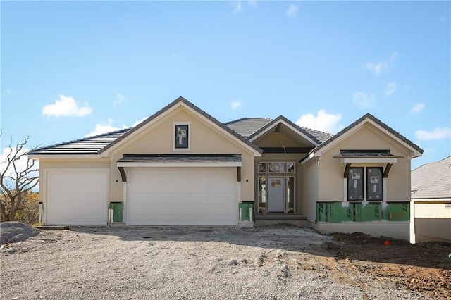 119 Teton Rdg, Lake Winnebago, MO 64034 - view of front of house featuring stucco siding, a tile roof, and a garage