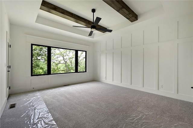 119 Teton Rdg, Lake Winnebago, MO 64034 - unfurnished room featuring carpet, ceiling fan, beamed ceiling, and a decorative wall