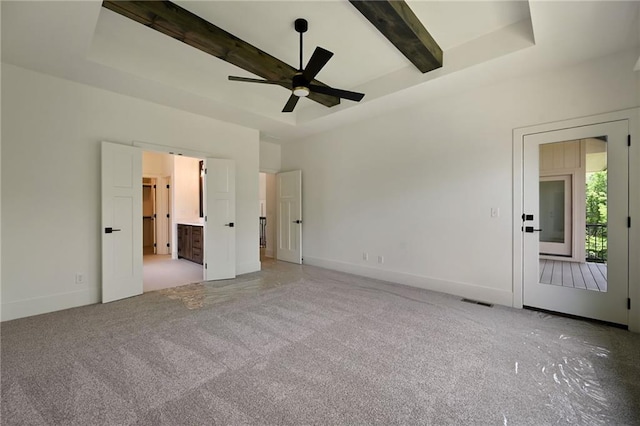 119 Teton Rdg, Lake Winnebago, MO 64034 - unfurnished bedroom with beam ceiling, light colored carpet, a tray ceiling, and ensuite bath