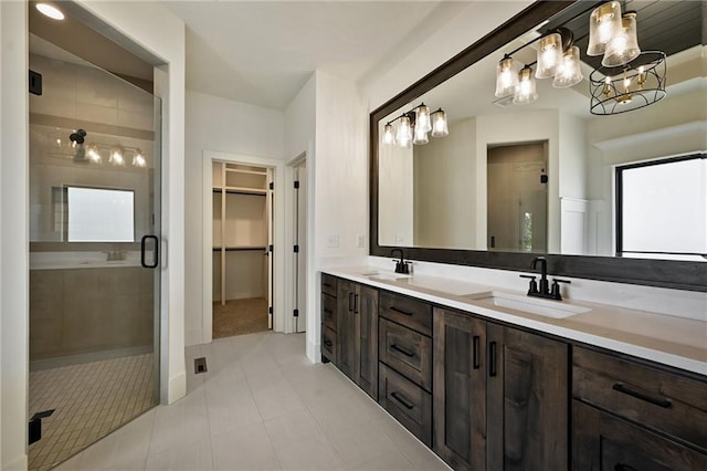 119 Teton Rdg, Lake Winnebago, MO 64034 - bathroom with a shower stall, double vanity, a spacious closet, tile patterned flooring, and a chandelier
