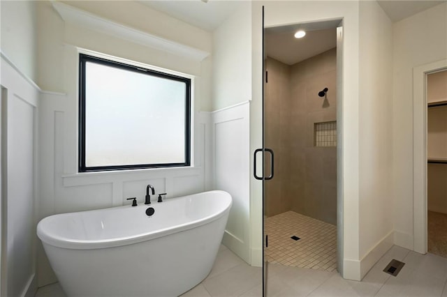 119 Teton Rdg, Lake Winnebago, MO 64034 - bathroom featuring a shower stall, a freestanding tub, a walk in closet, and tile patterned flooring