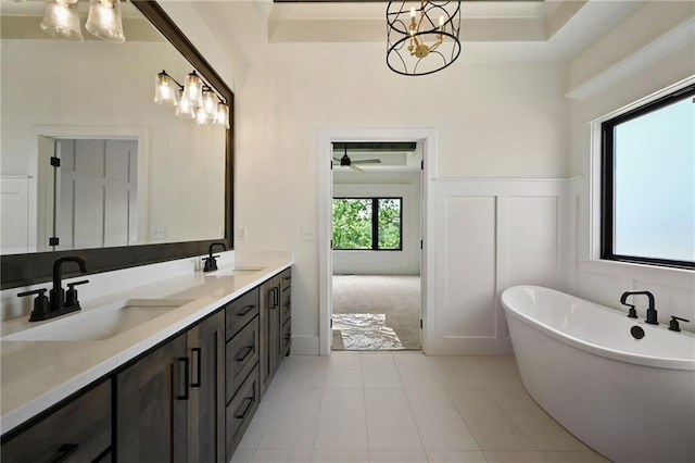 119 Teton Rdg, Lake Winnebago, MO 64034 - full bath with double vanity, a freestanding bath, a chandelier, and tile patterned floors