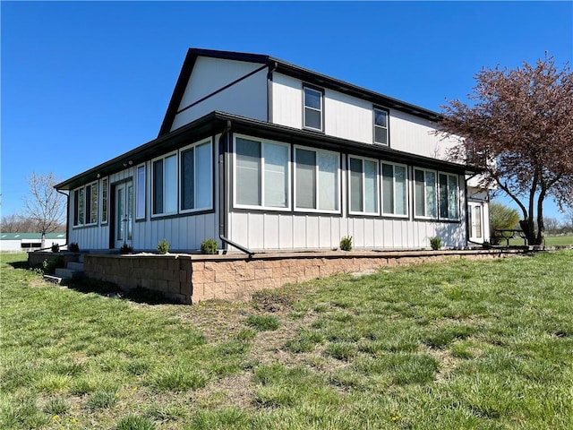 view of side of home featuring a yard