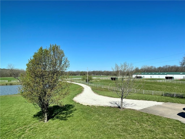 surrounding community with a rural view and a yard