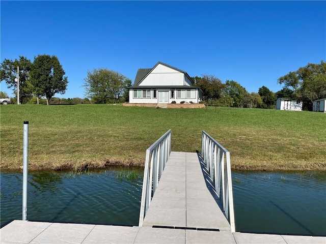 view of dock featuring a water view and a lawn