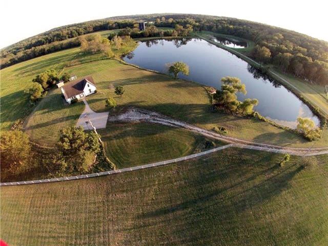 birds eye view of property with a rural view and a water view