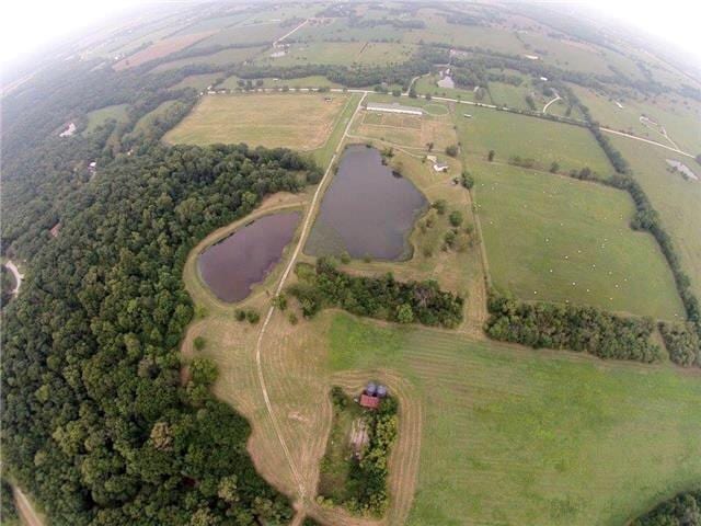 birds eye view of property featuring a rural view and a water view