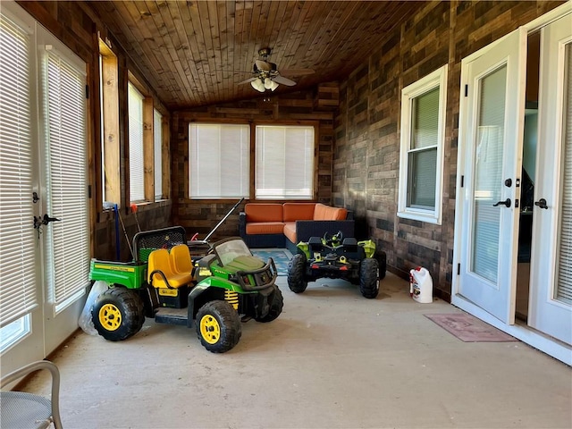 exterior space with ceiling fan, wood ceiling, and vaulted ceiling