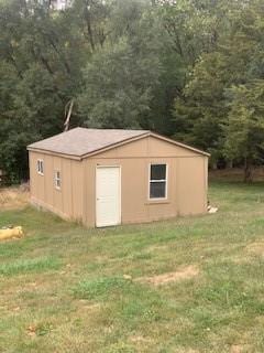 view of outdoor structure with a yard