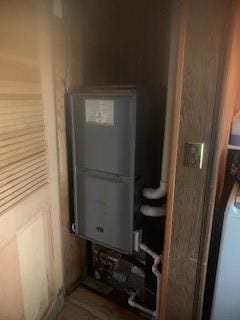 utility room featuring water heater