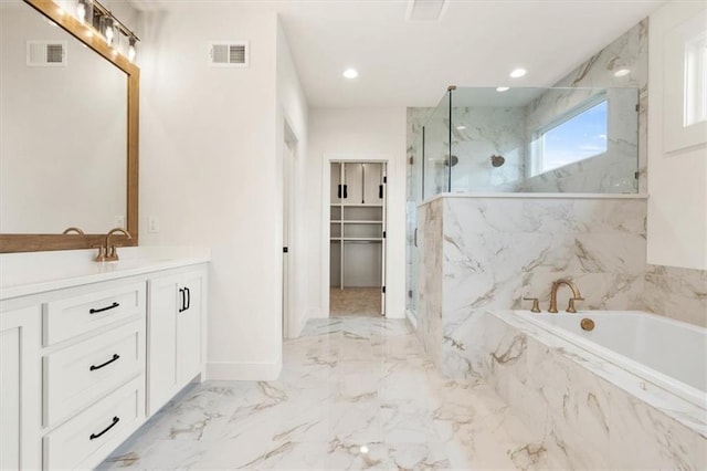 bathroom with tile floors, separate shower and tub, and large vanity