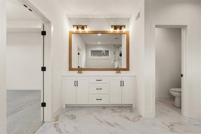 bathroom with toilet, tile flooring, and double sink vanity