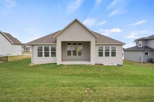 back of house with a patio area and a yard