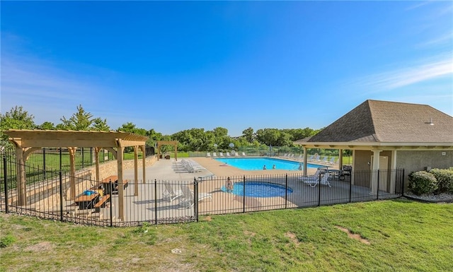 view of pool with a lawn and a patio area